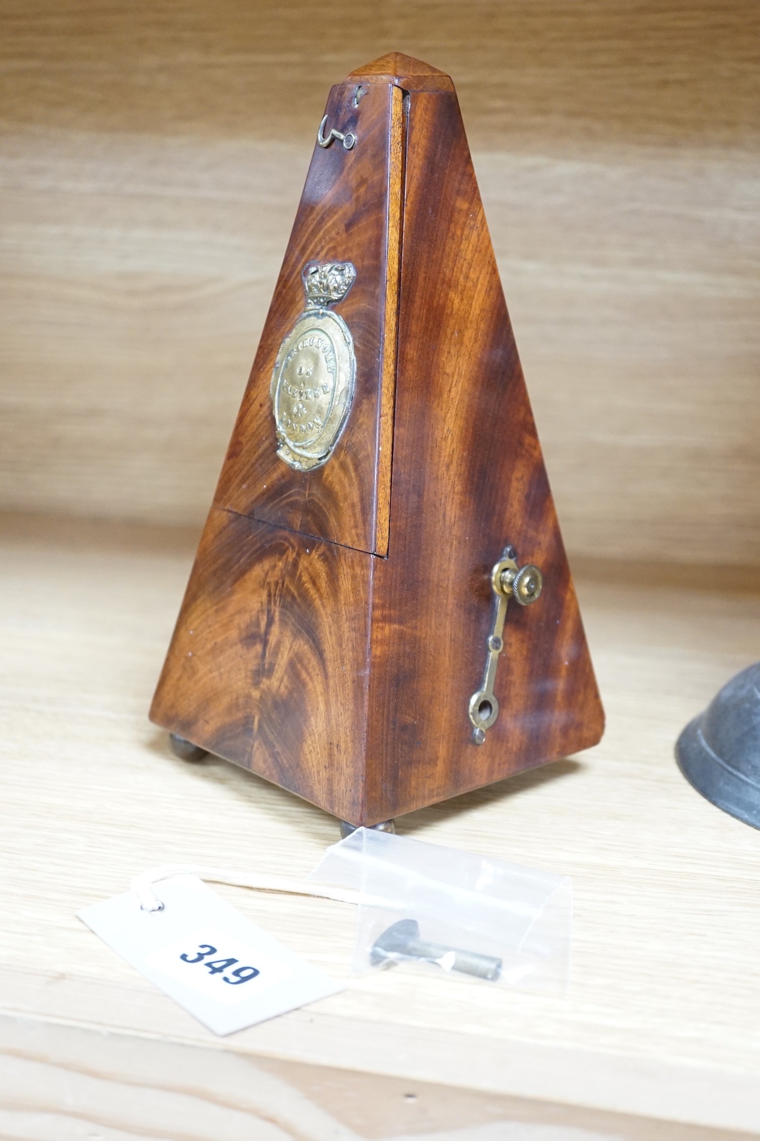 A 19th century mahogany metronome with key, 23ms high